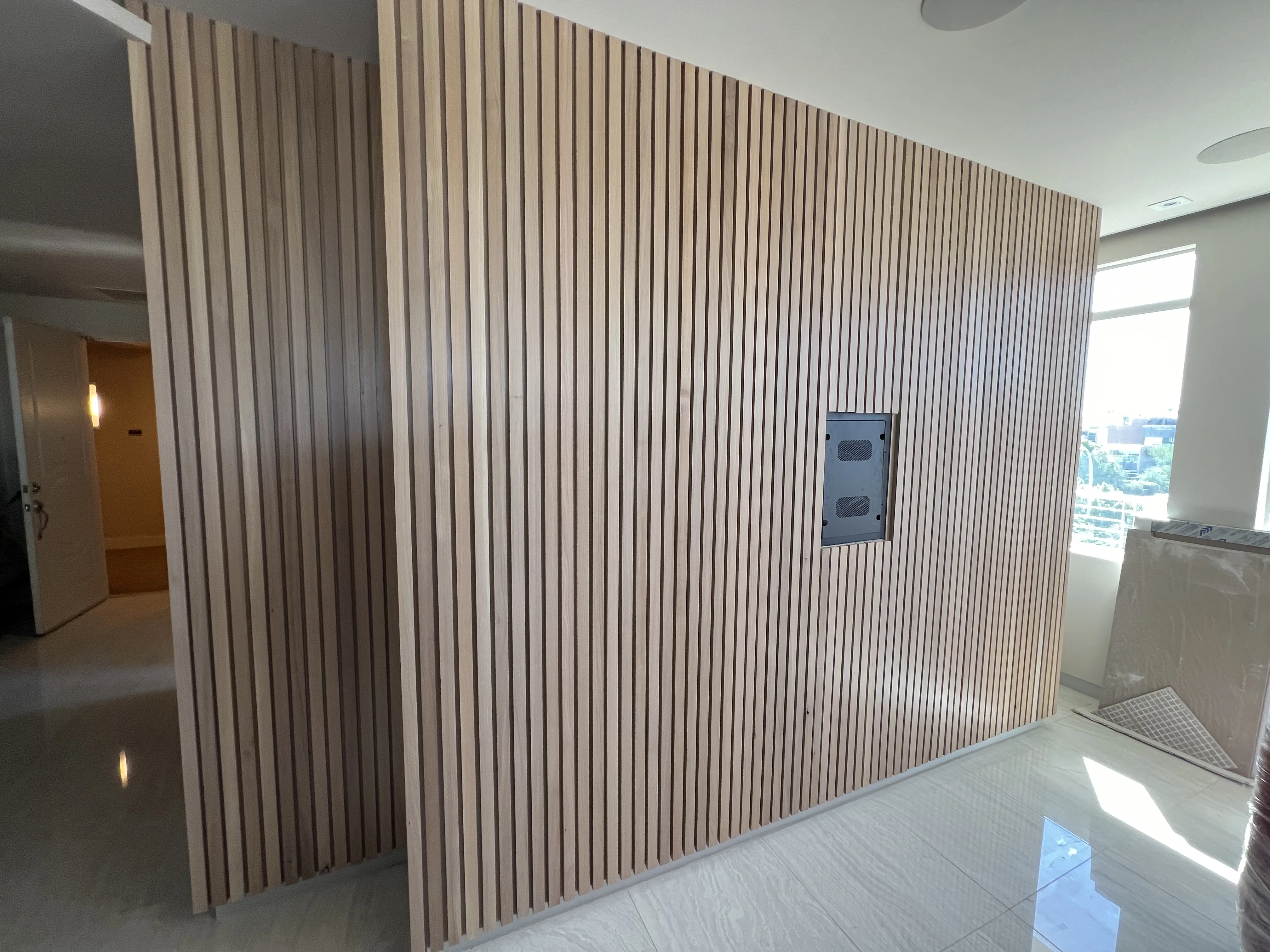 Solid oak slatted wall with hidden door in Scottsdale, AZ