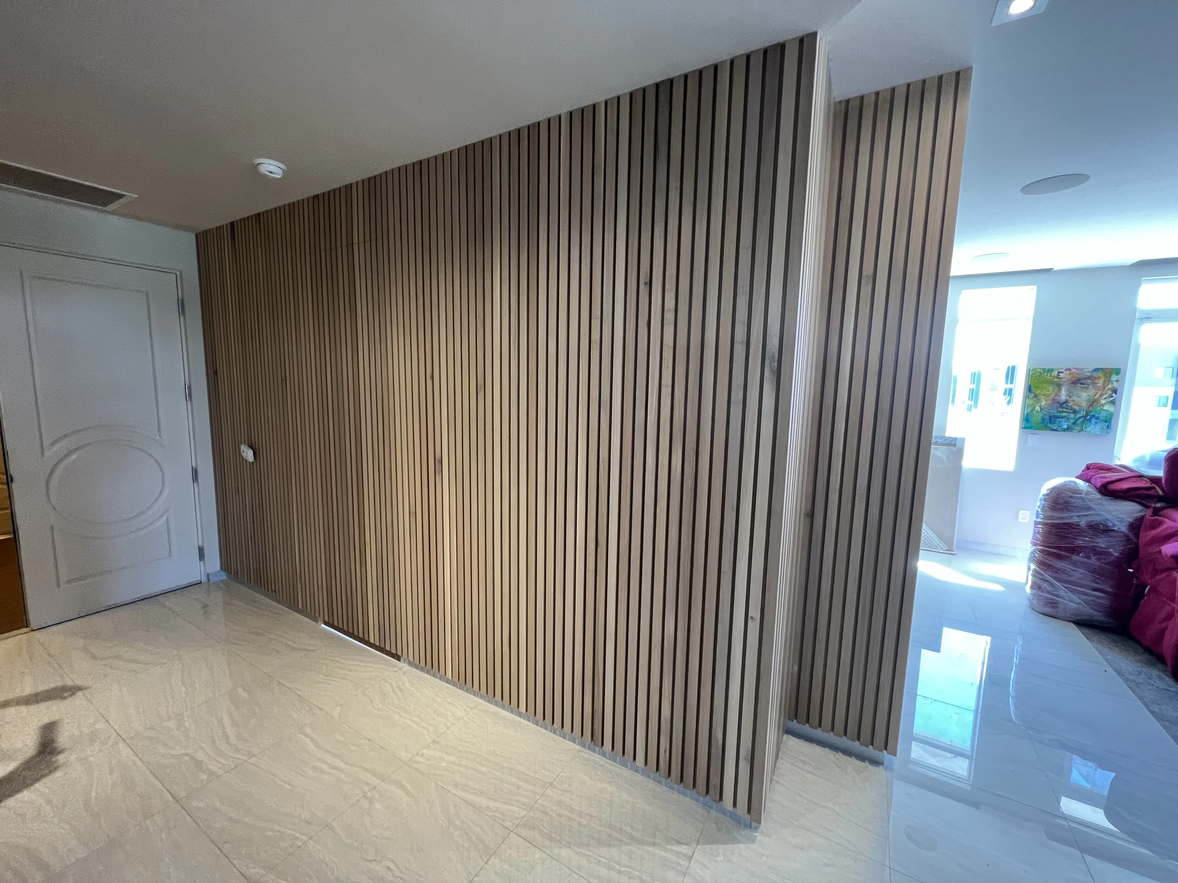 Solid oak slatted wall with hidden door in Scottsdale, AZ