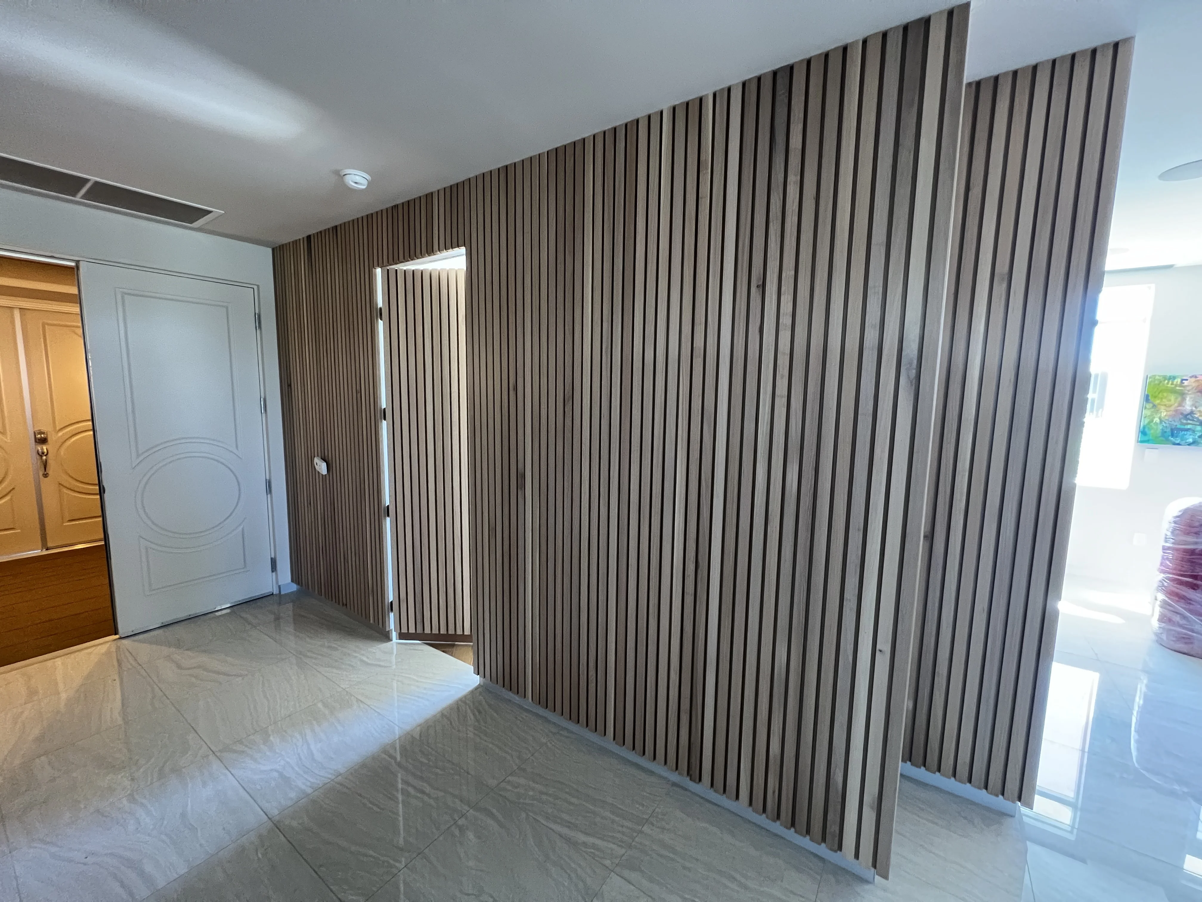 Solid oak slatted wall with hidden door in Scottsdale, AZ